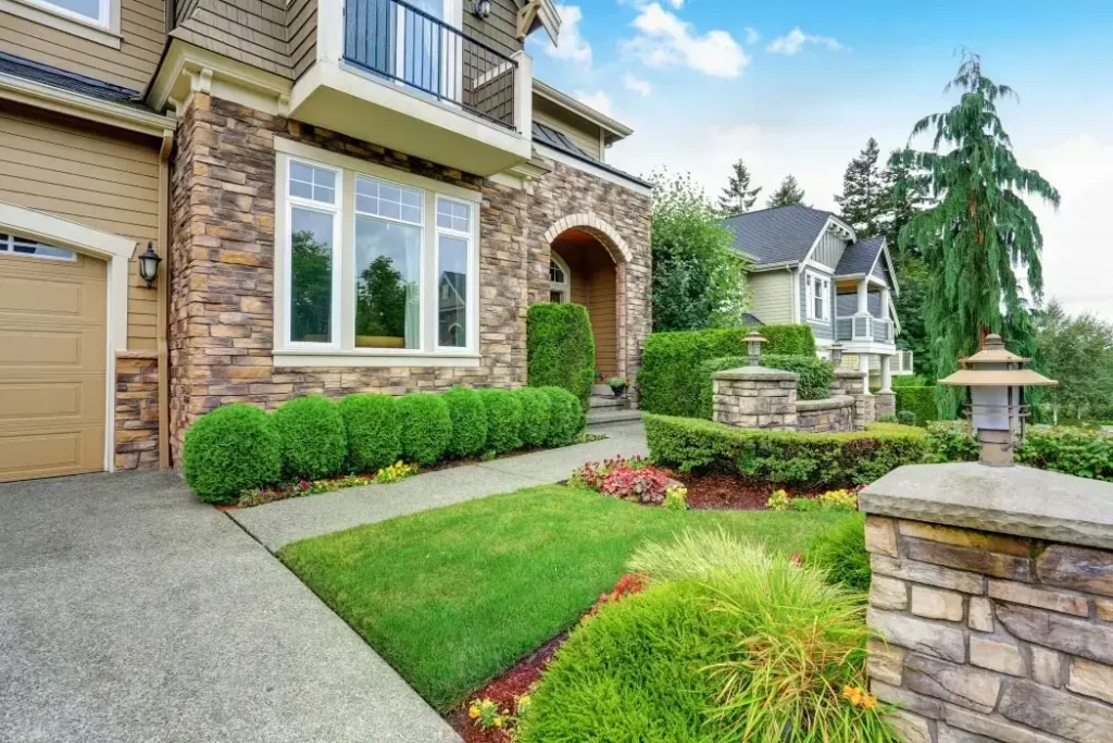 Lawn mower cutting green grass in a home garden